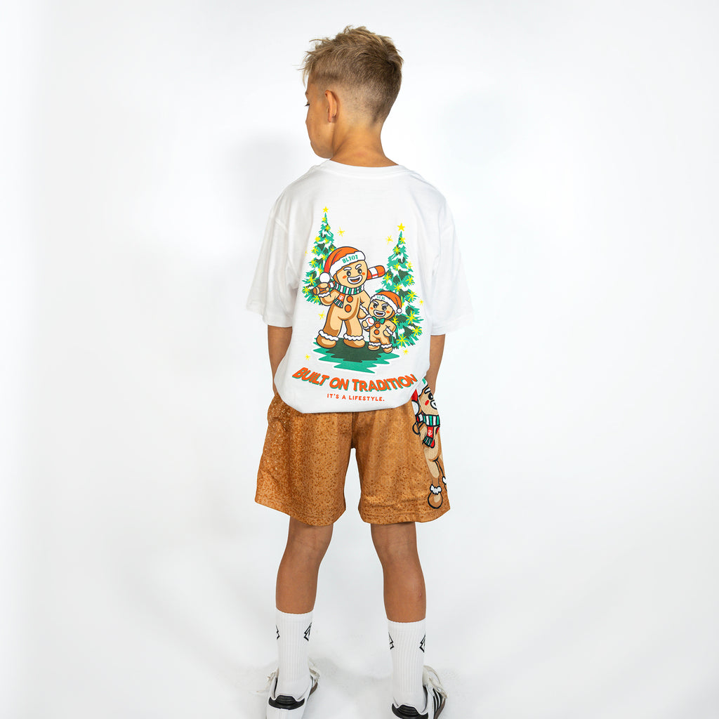 Youth model wearing brown youth shorts with "Gingerbread Rookie" design