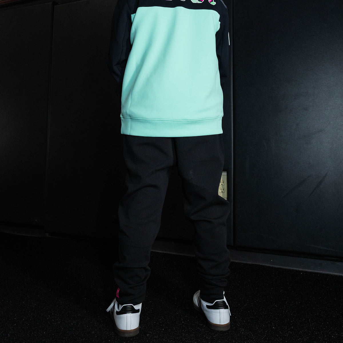 Youth model wearing black relaxed fit joggers with "King Of JUCO Diamond" design