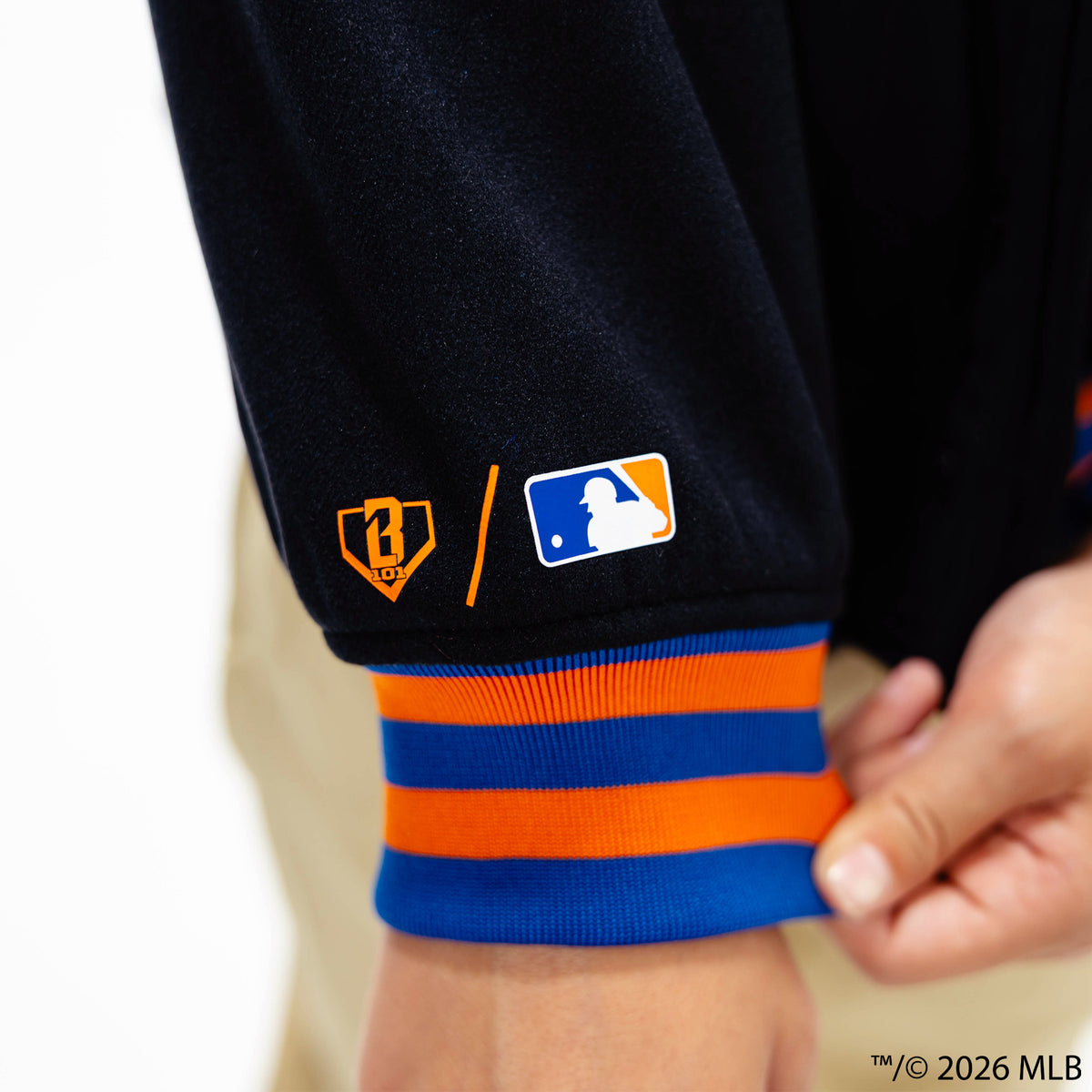 Youth model wearing black New York Mets Stadium youth bomber jacket