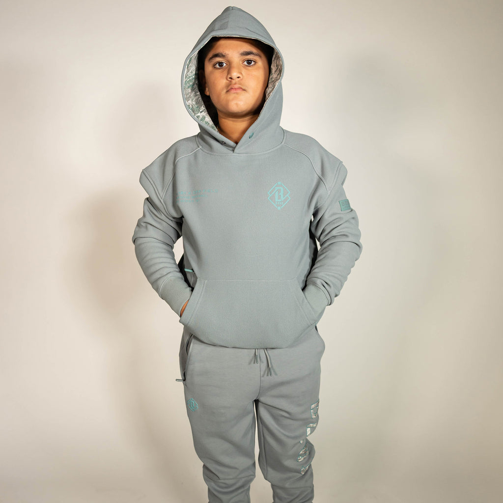 Youth model wearing gray Realtree Aspect Off-Field Waffle Performance Camo youth hoodie