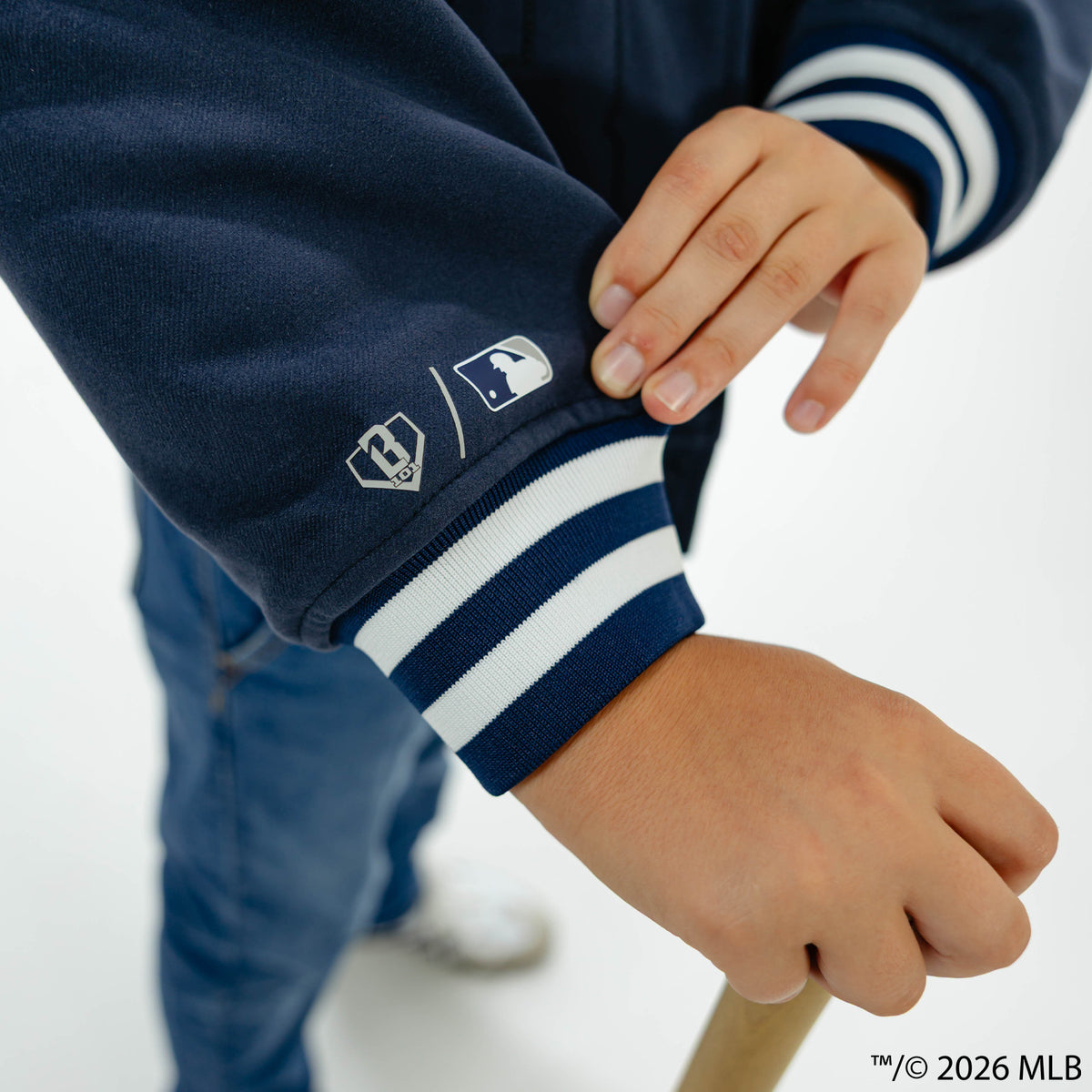 Youth model wearing navy New York Yankees Stadium youth bomber jacket