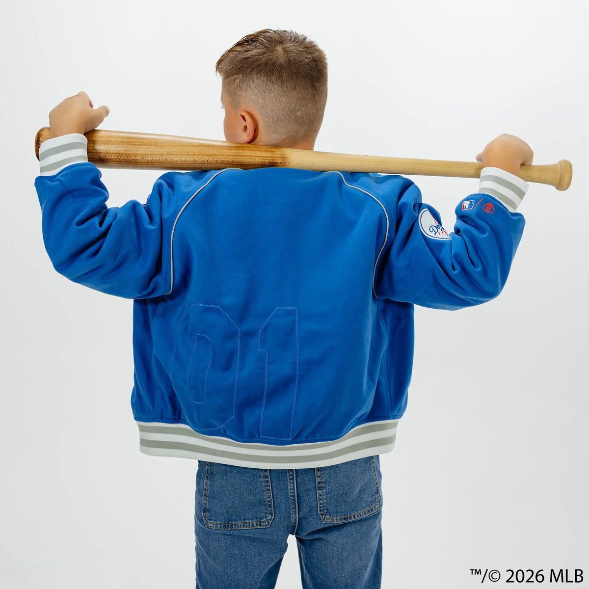 Youth model wearing blue Los Angeles Dodgers Stadium youth bomber jacket