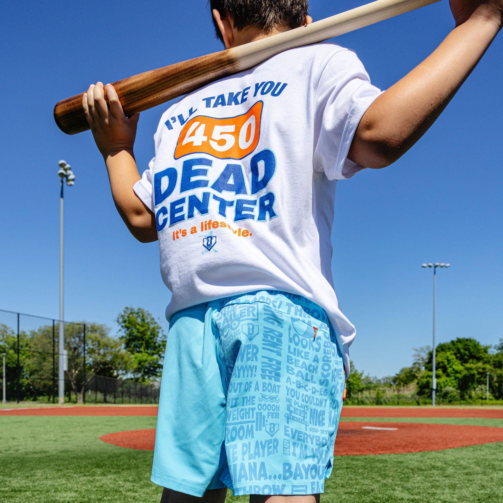 Youth model wearing blue youth shorts with "UVChangeup Trash Talk Youth" design