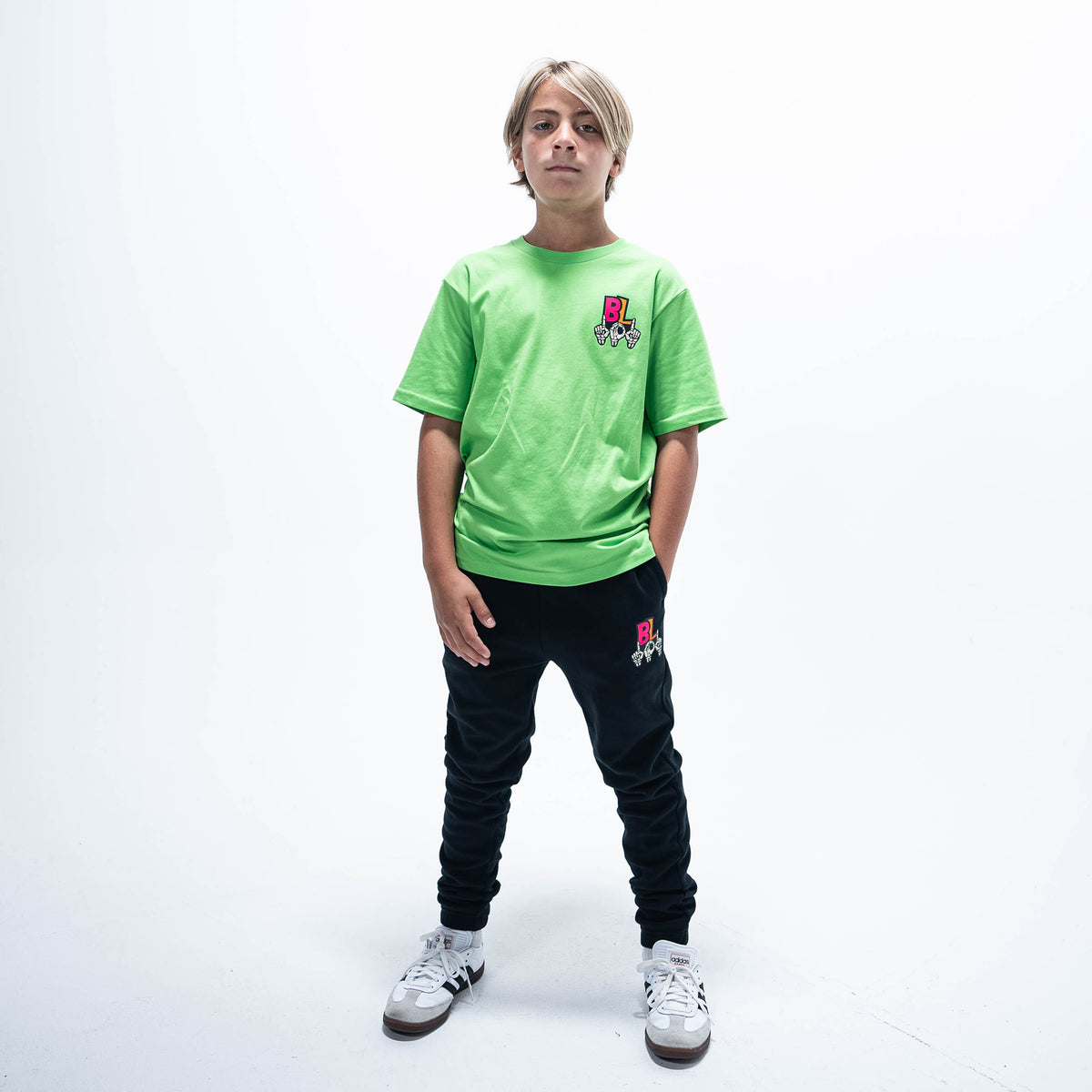 Youth model wearing black youth joggers with "101 Skeleton" design