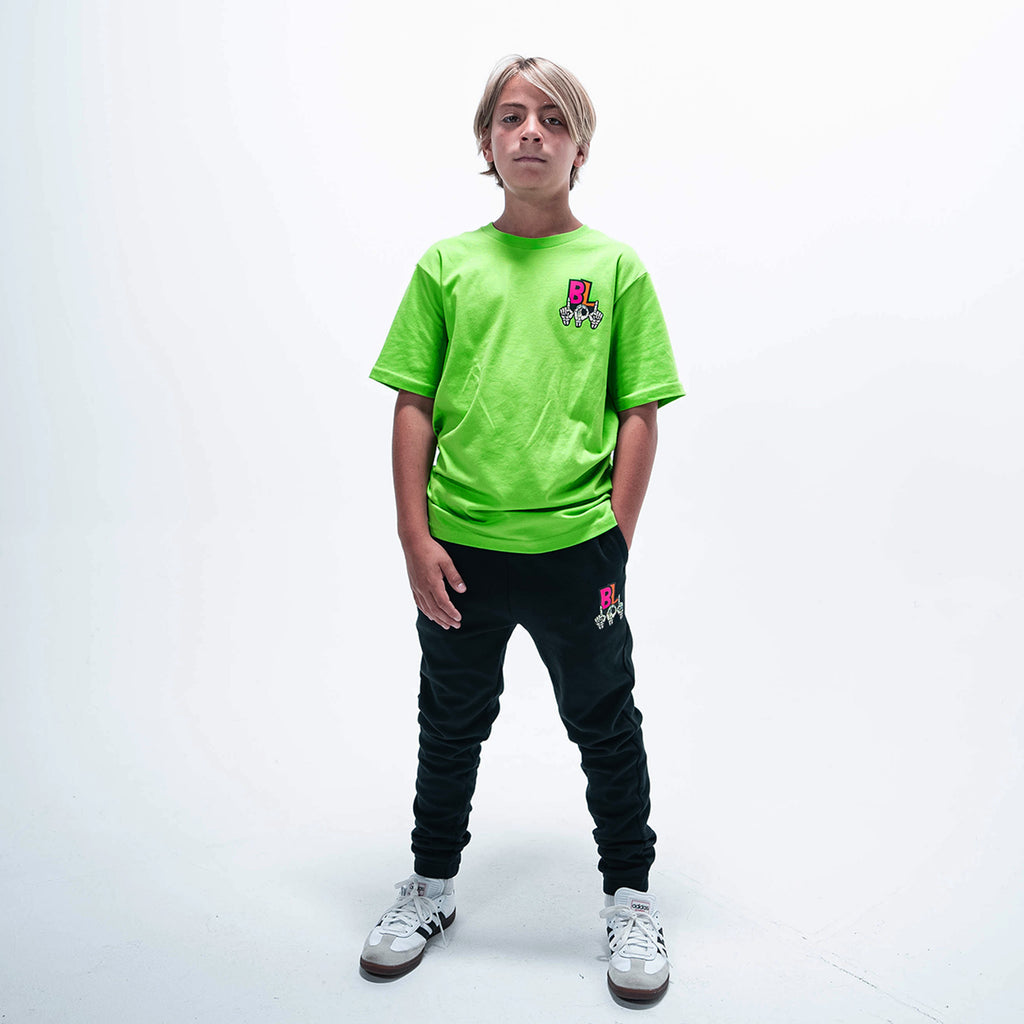 Youth model wearing green youth graphic tee with "101 Skeleton" design