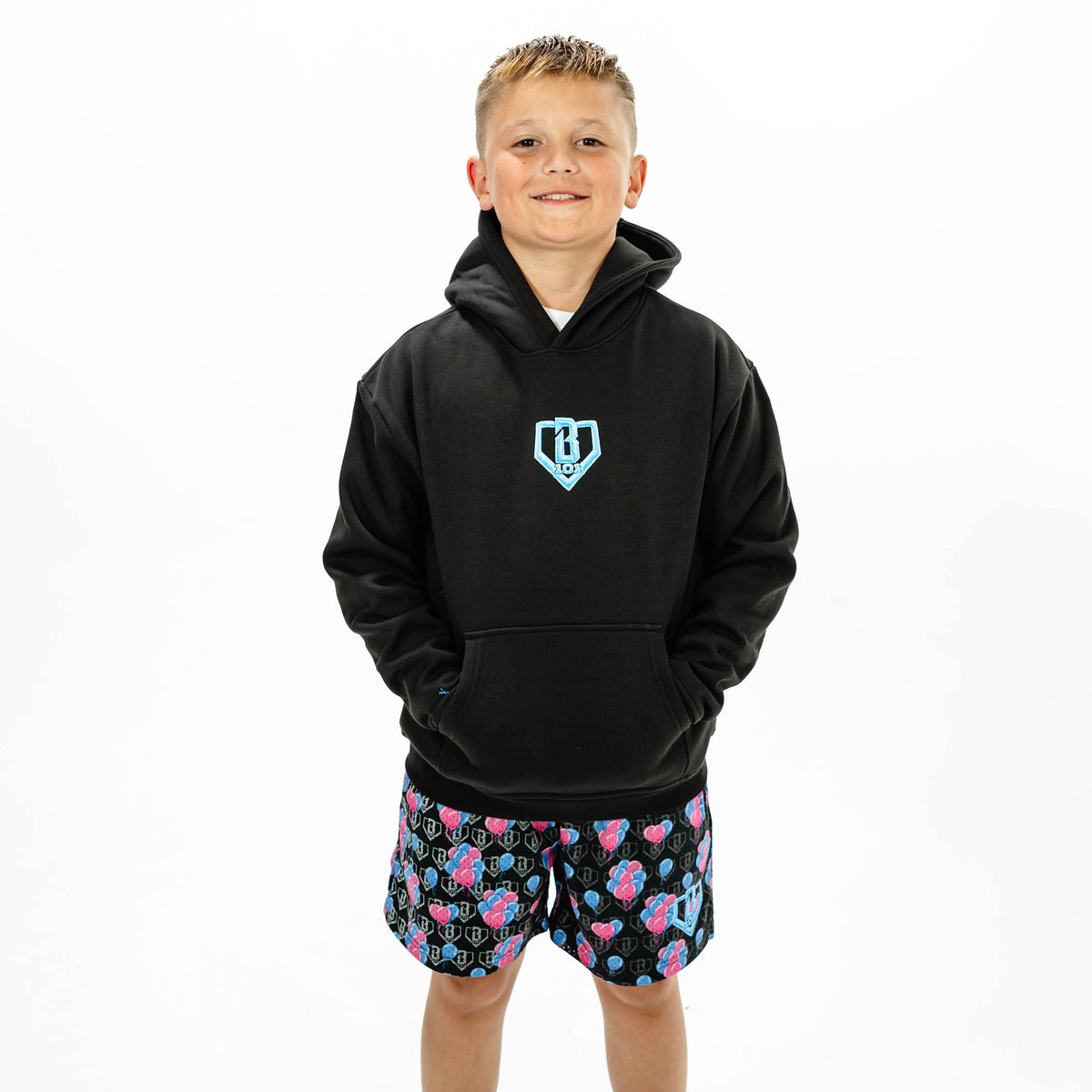 Youth model wearing black youth hoodie with "10 Year Anniversary" design