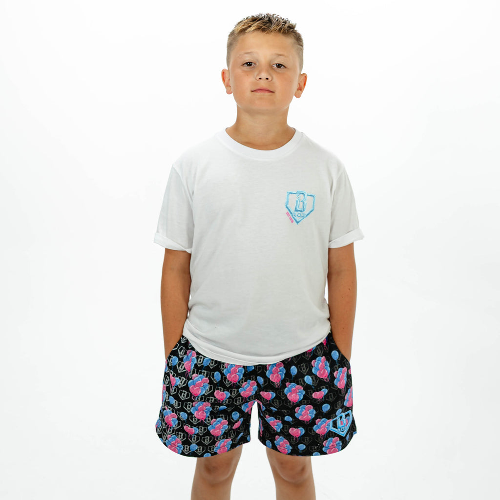 Youth model wearing blue youth shorts with "10 Year Anniversary" design