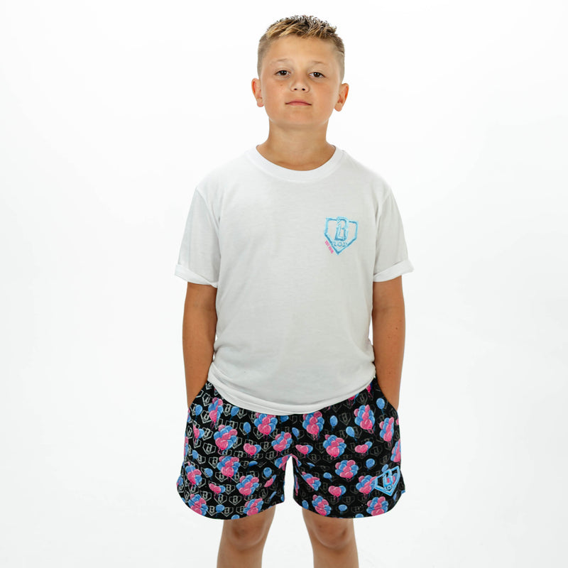 Youth model wearing blue youth shorts with "10 Year Anniversary" design