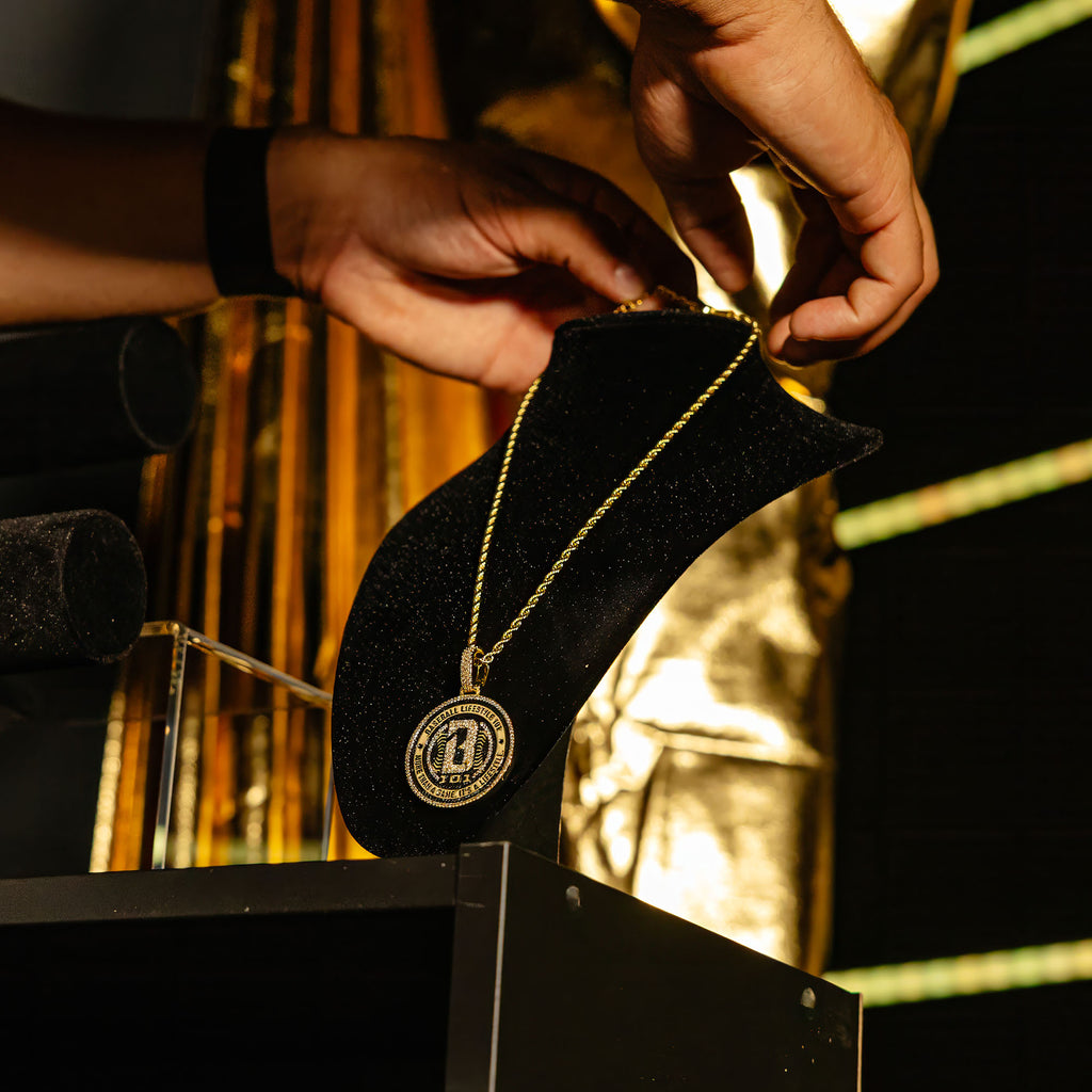 BL101 Medallion necklace hanging on a display stand