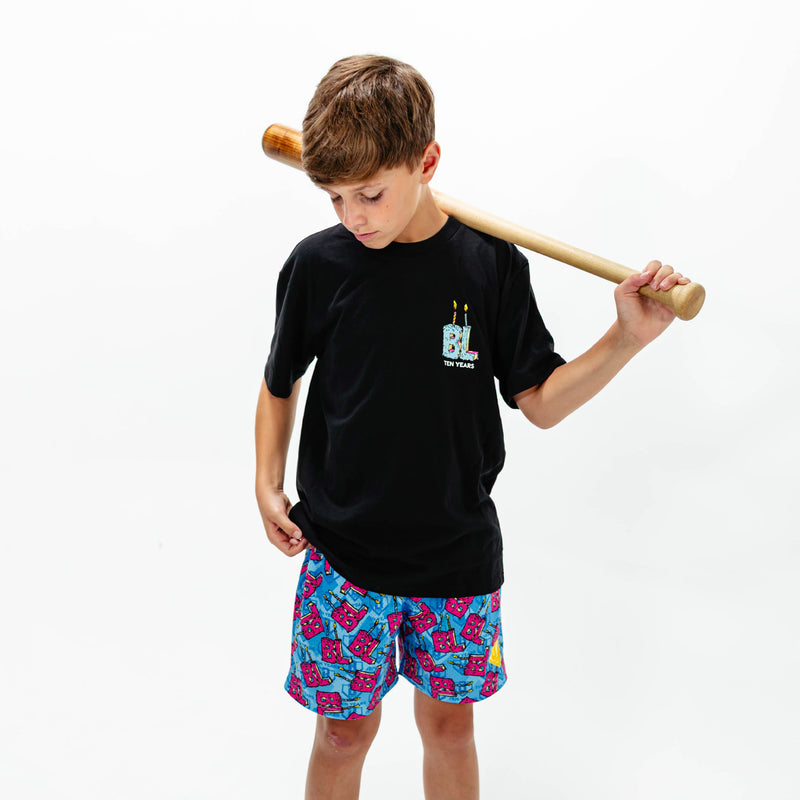 Youth model wearing blue youth shorts with "BL Birthday" design