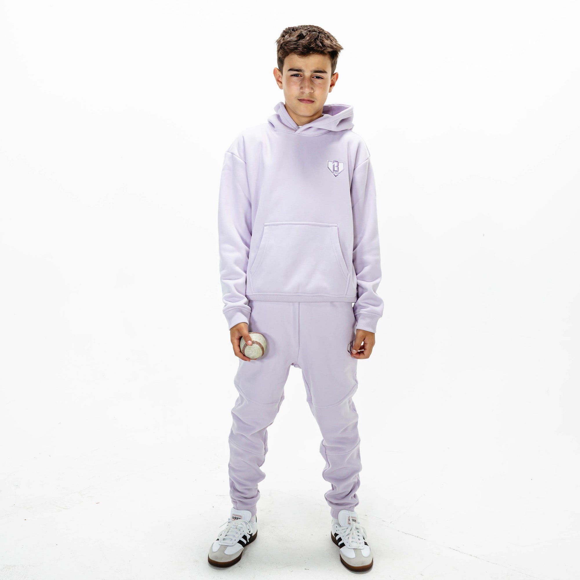 Youth model wearing Purple Baseline hoodie