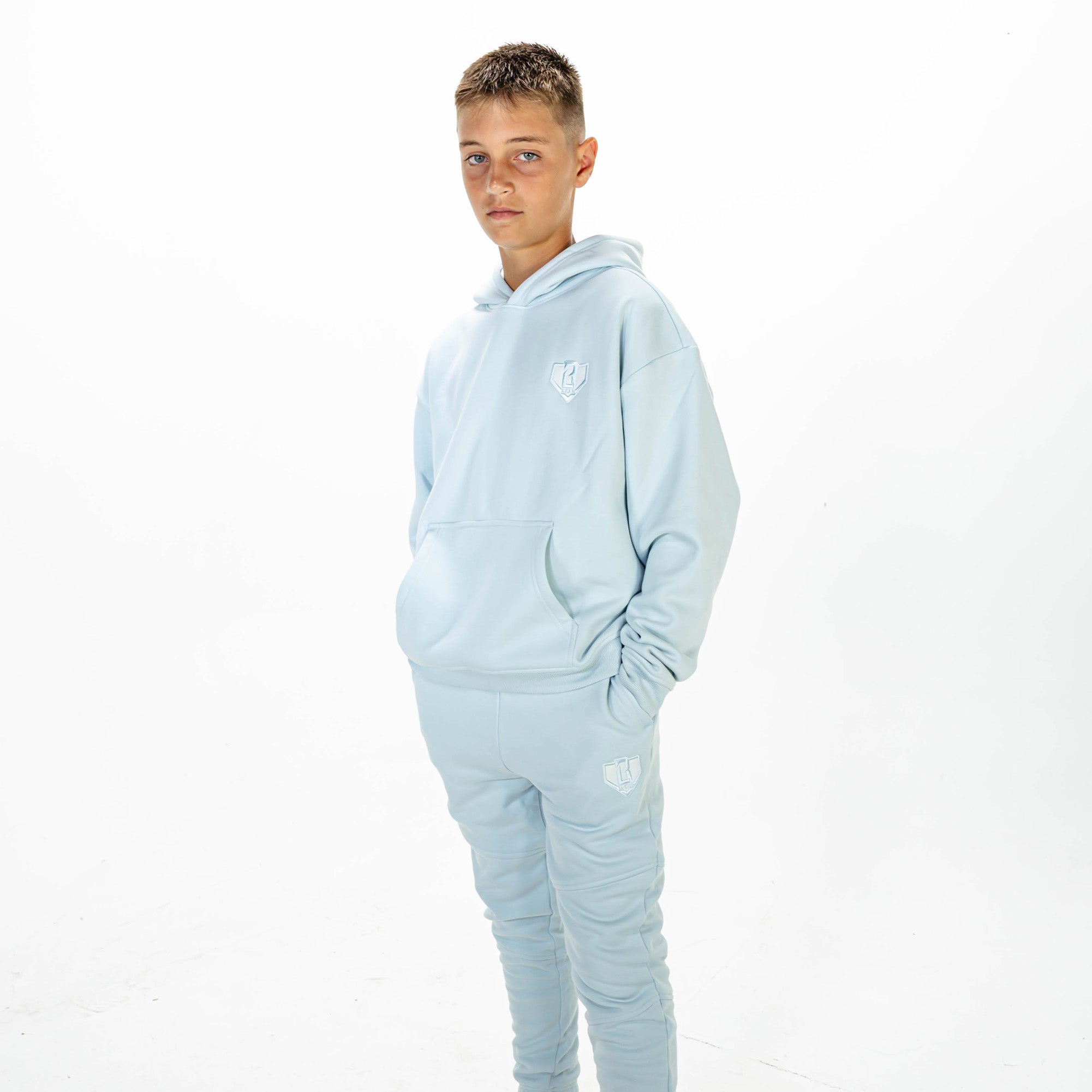 Youth model wearing Blue Baseline hoodie