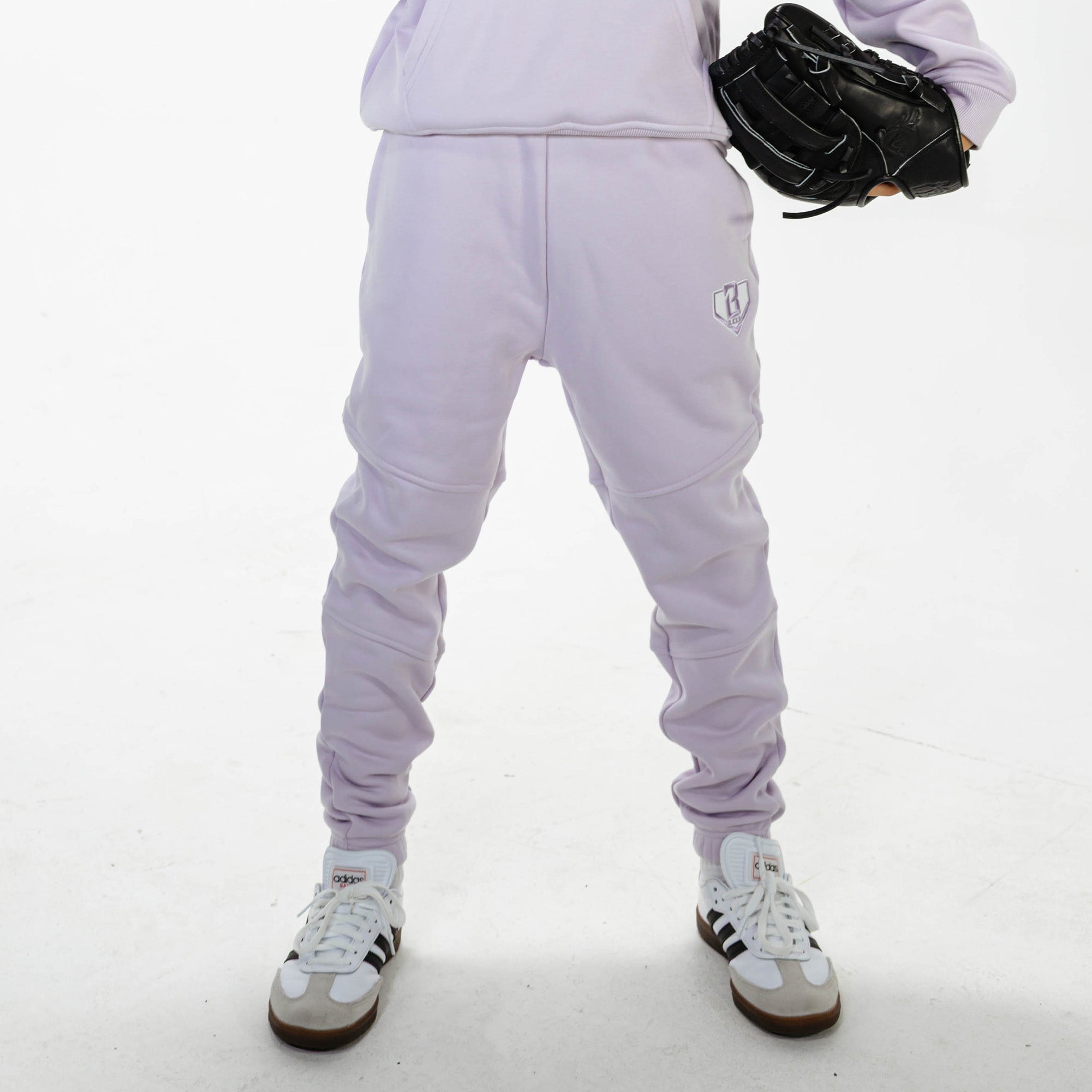 Youth model wearing Purple Baseline joggers