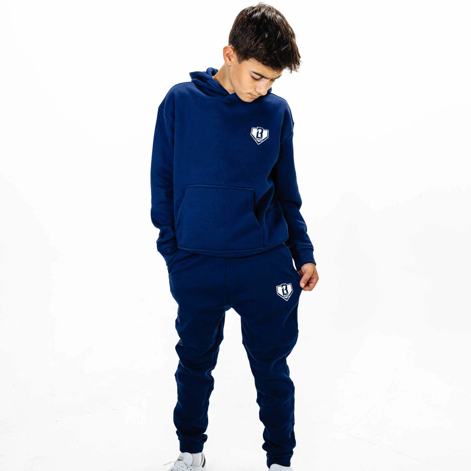 Youth model wearing Navy Baseline joggers