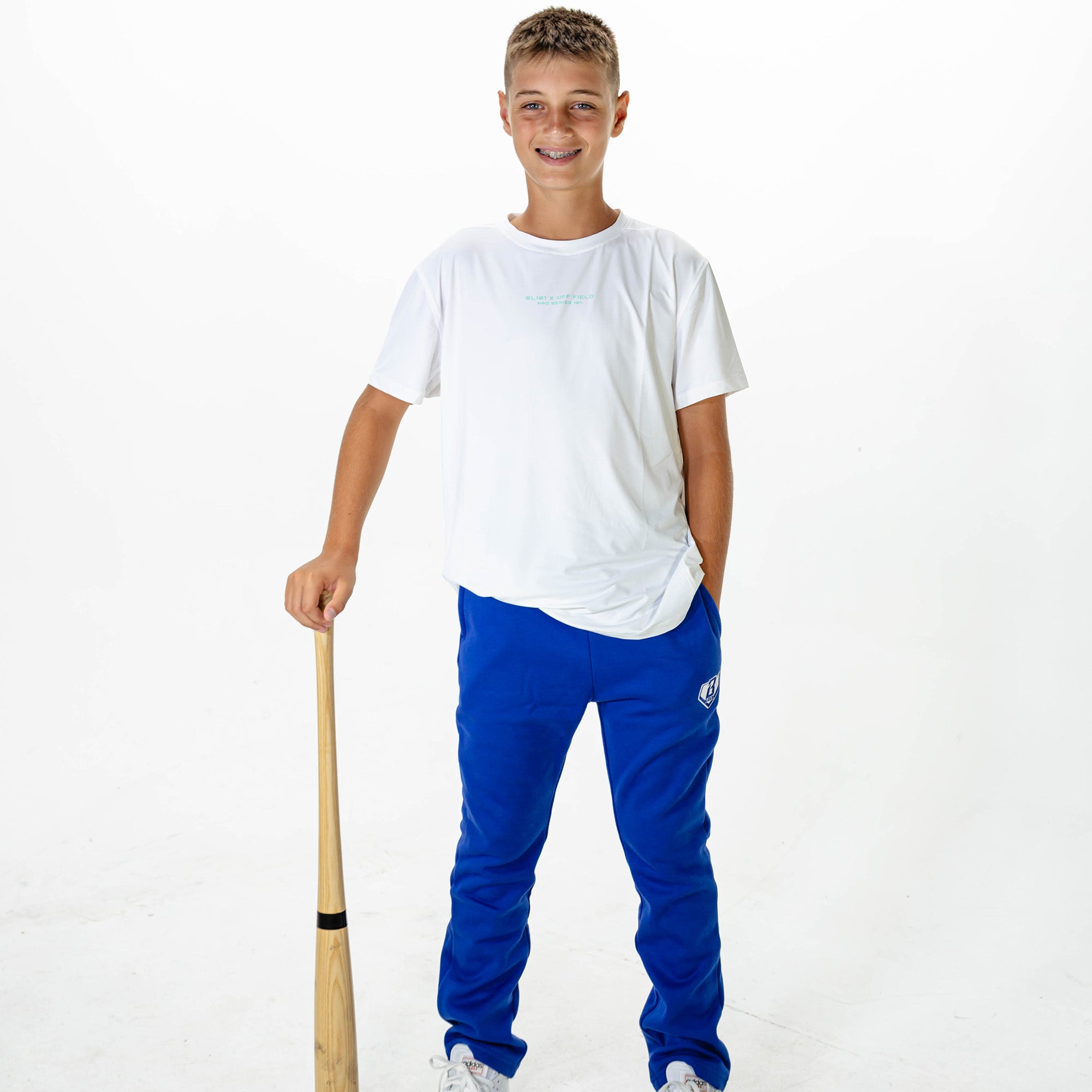 Youth model wearing Blue Baseline Straight Leg sweatpants