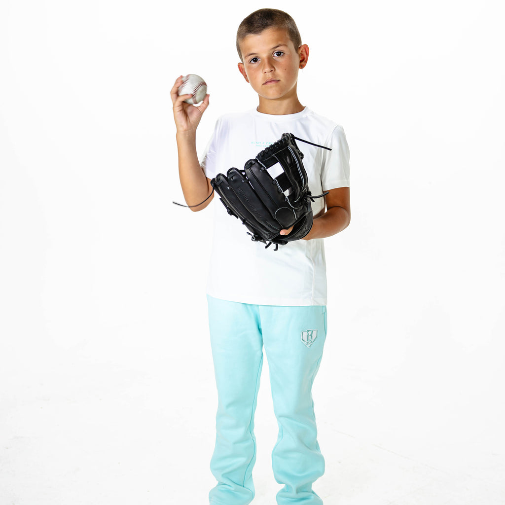 Youth model wearing Blue Baseline Straight Leg sweatpants
