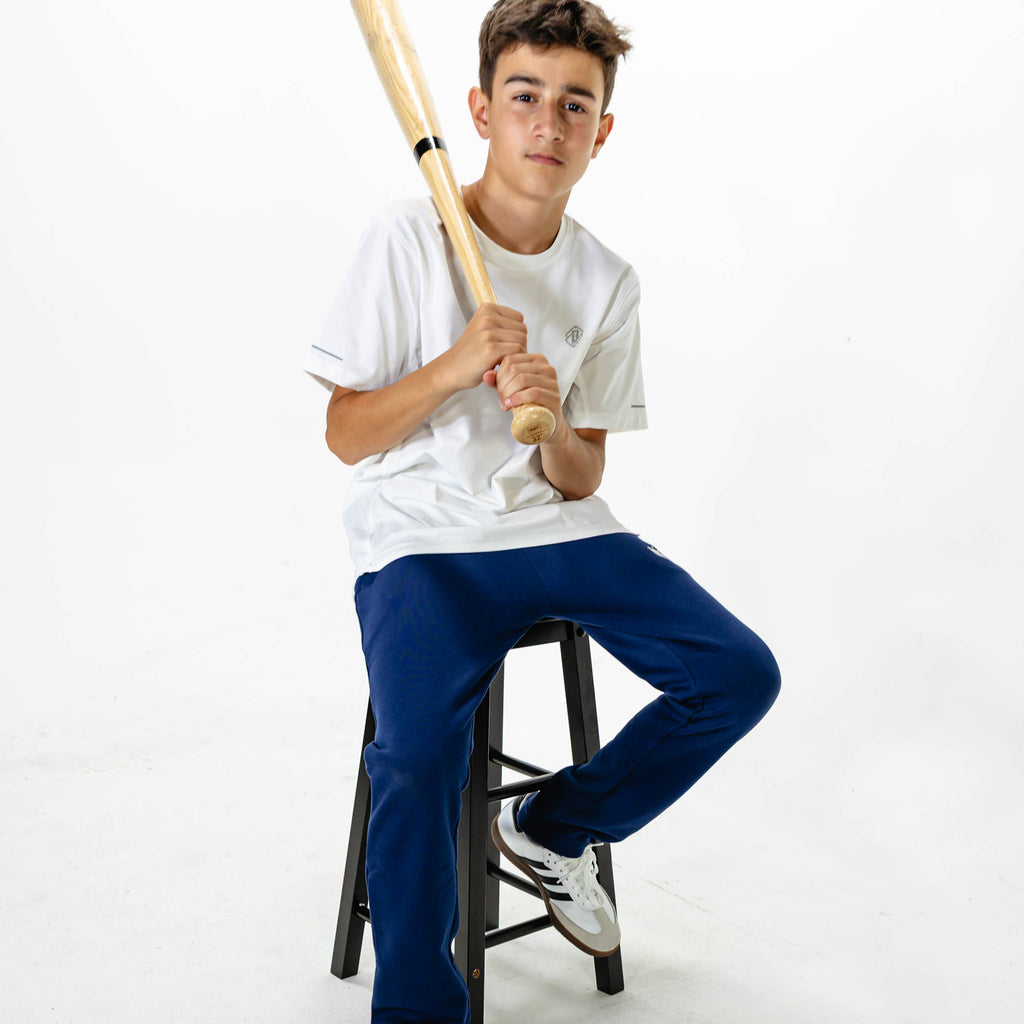 Youth model wearing Navy Baseline Straight Leg sweatpants