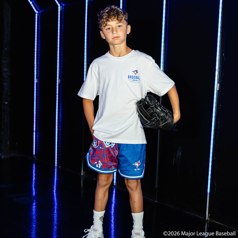 Youth model wearing blue youth shorts with "Toronto Blue Jays Sticker Court" design