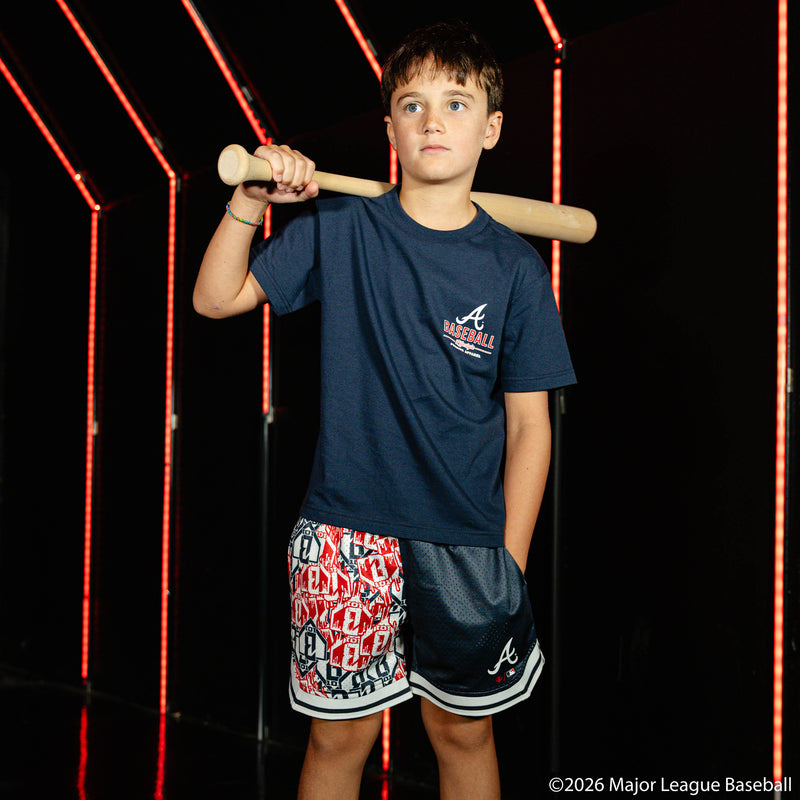 Youth model wearing navy youth shorts with "Atlanta Braves Sticker Court" design