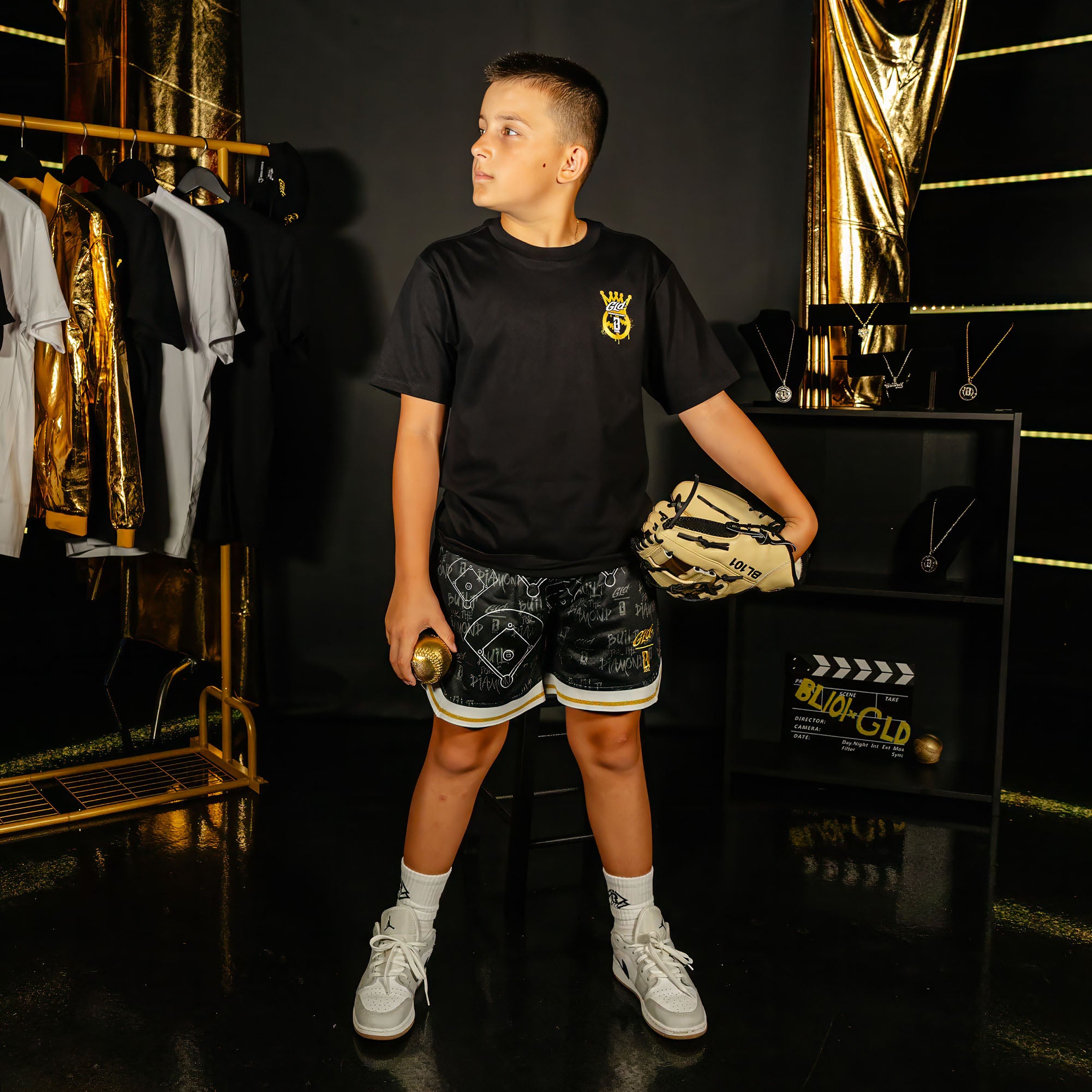 Youth model wearing black youth shorts with "Built For The Diamond" design