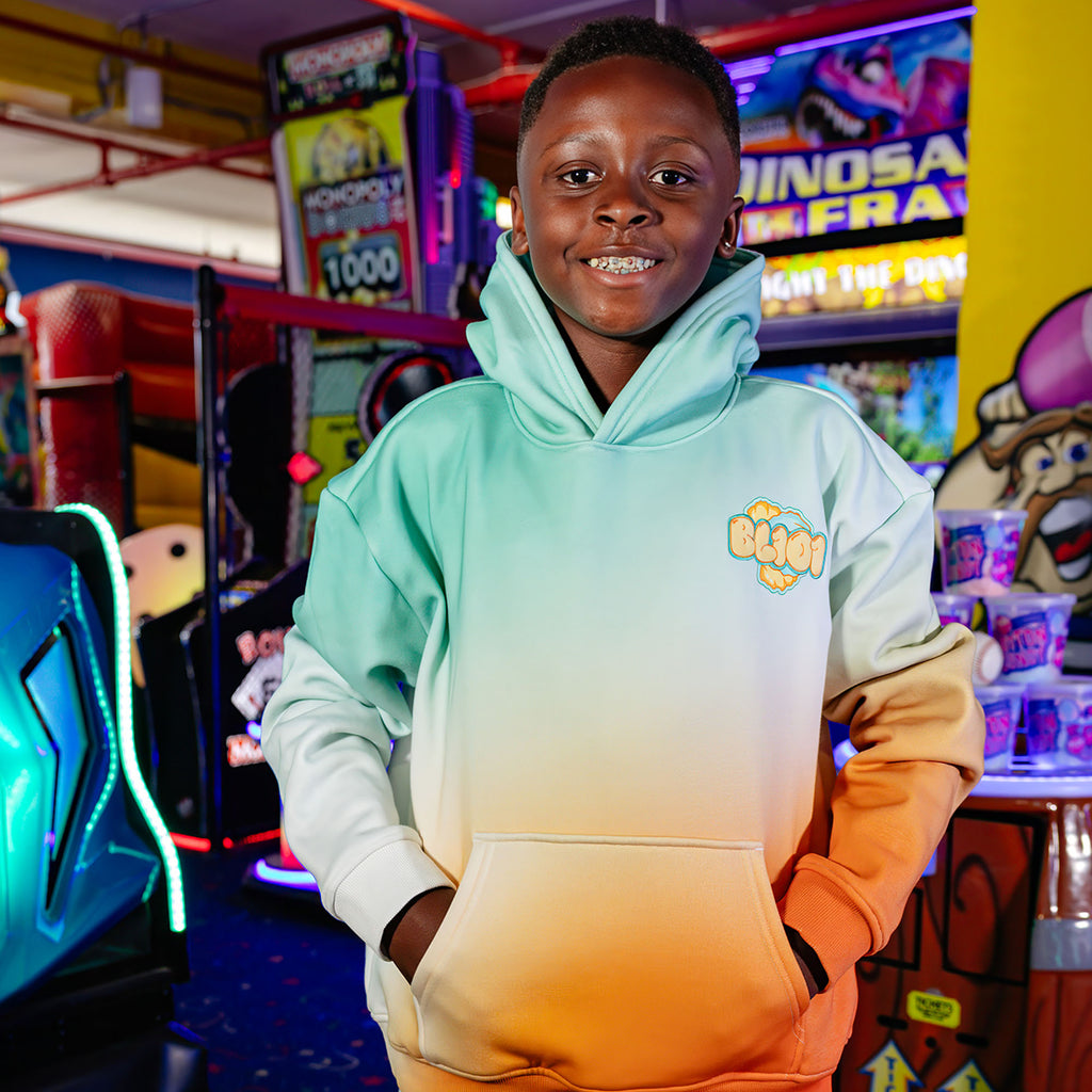 Youth model wearing Cotton Candy Tangerine Freeze youth hoodie