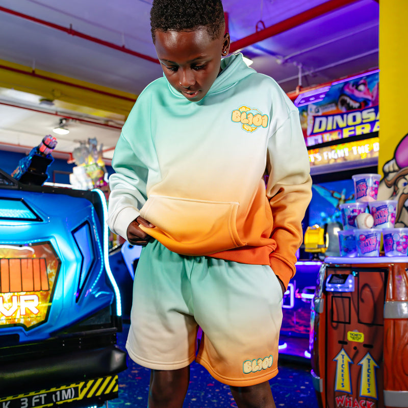 Youth model wearing Cotton Candy Tangerine Freeze youth shorts