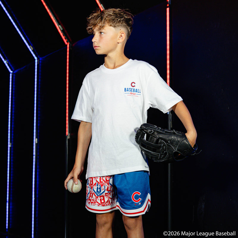 Youth model wearing blue youth shorts with "Chicago Cubs Sticker Court" design