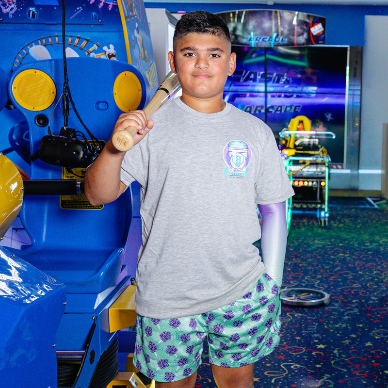 Youth model wearing Home Run Sugar Galaxy Grape youth shorts