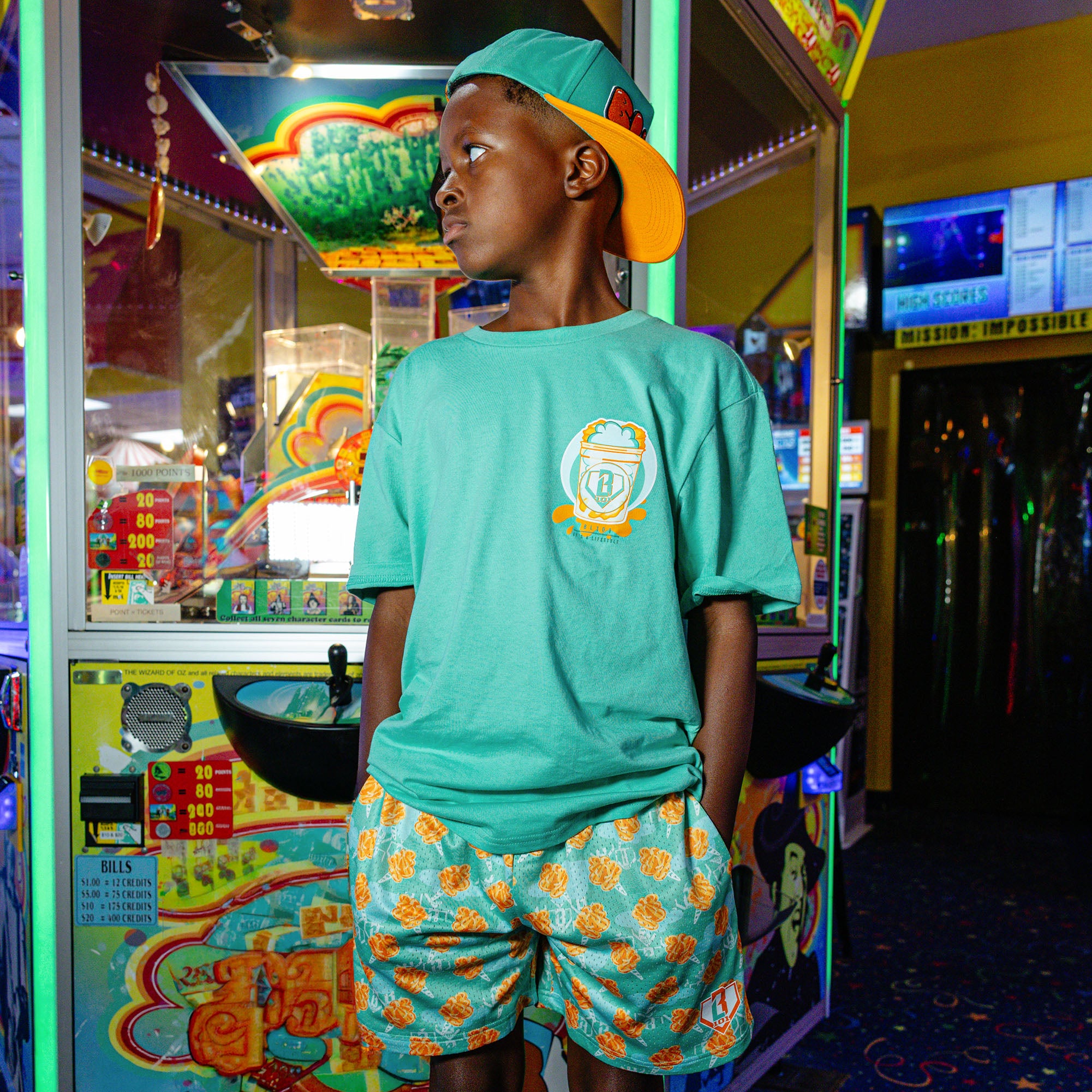 Youth model wearing Home Run Sugar Tangerine Freeze youth shorts