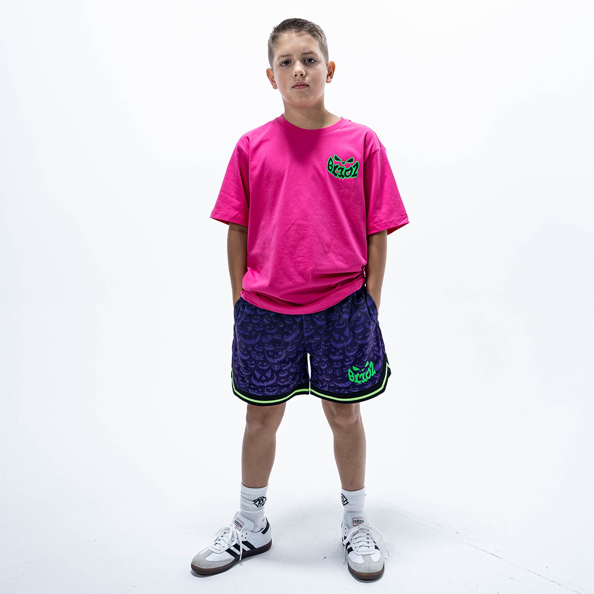 Youth model wearing pink youth graphic tee with "Jack O' Lantern Team" design