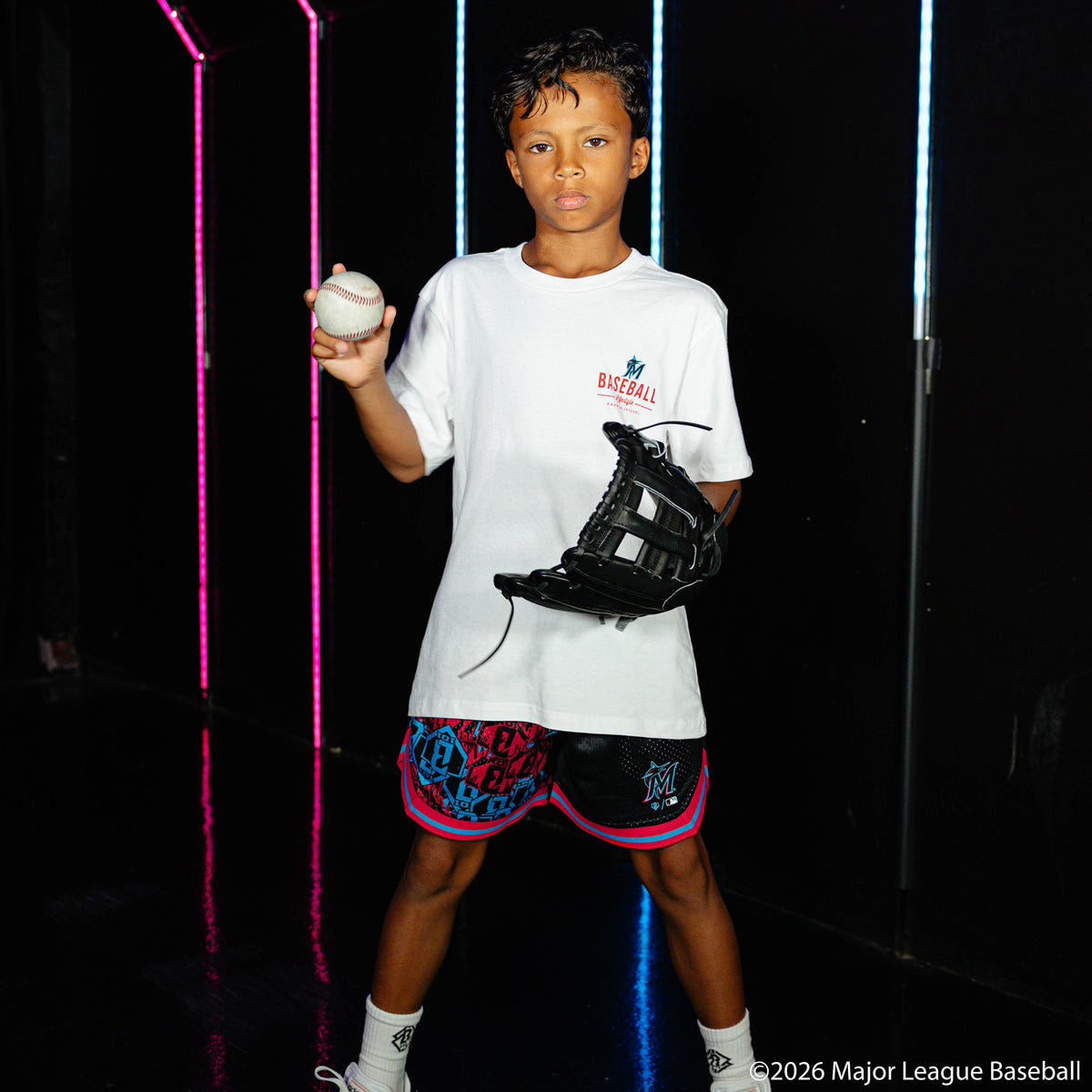 Youth model wearing white youth graphic tee with "Miami Marlins Ice Cream Cap" design