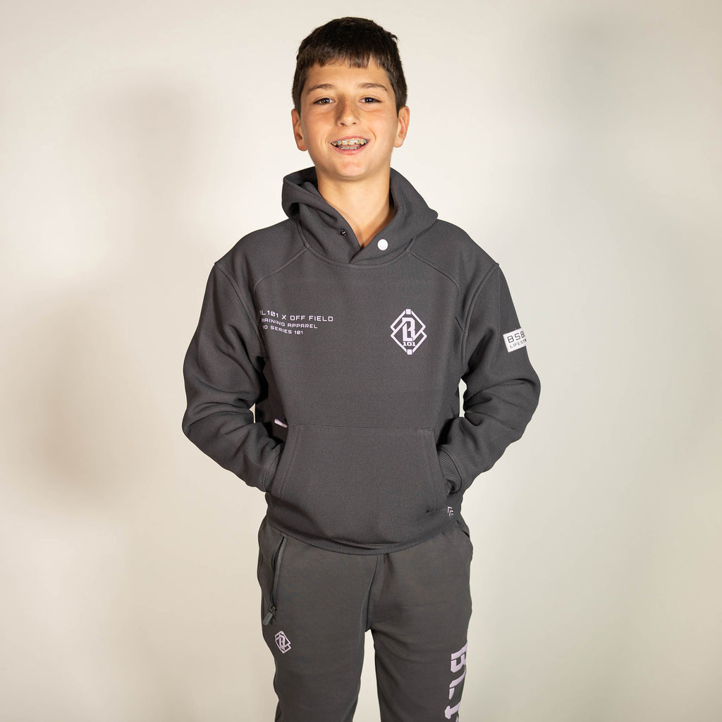 Youth model wearing gray and lilac Off-Field Waffle Performance youth hoodie