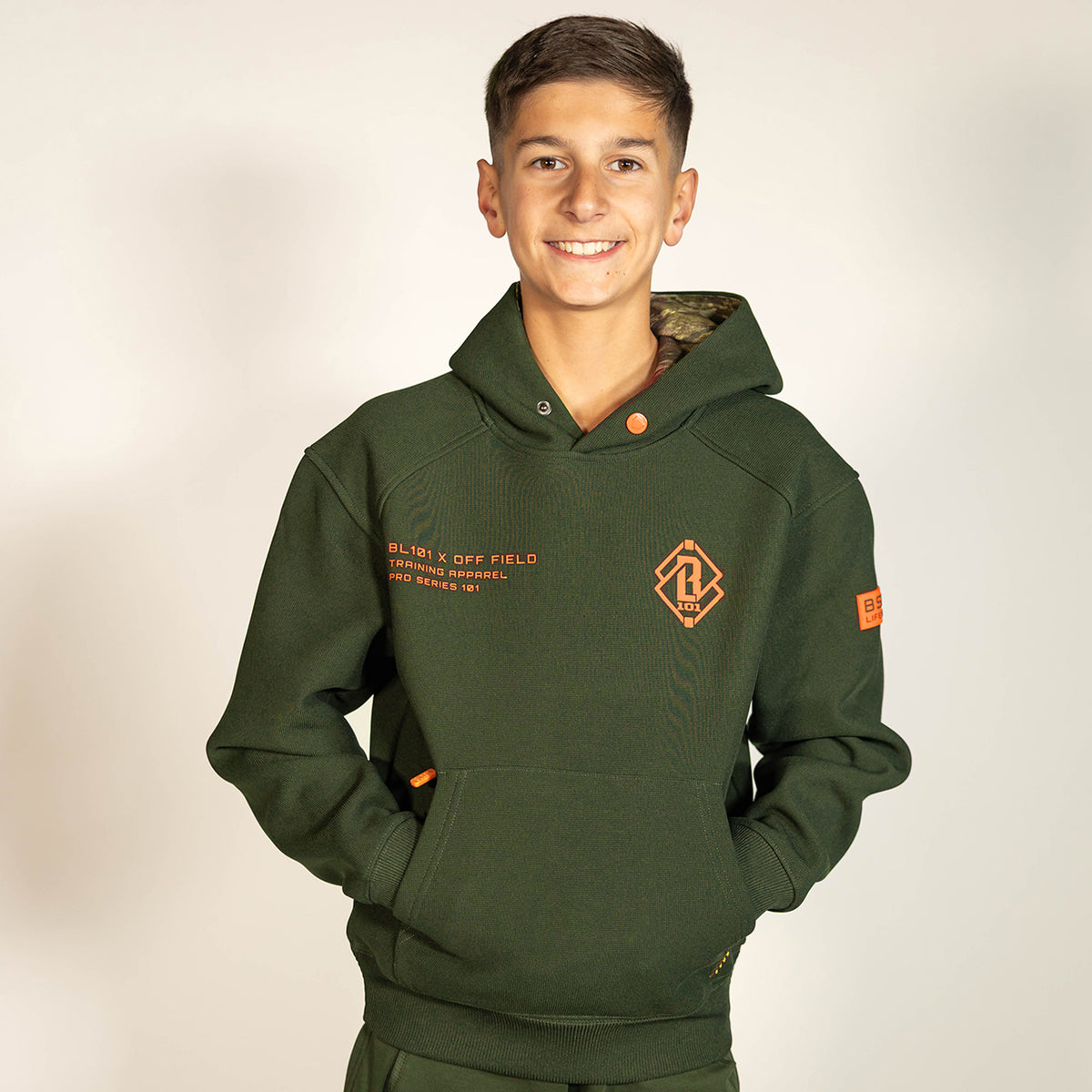 Youth model wearing green Realtree Legacy Off-Field Waffle Performance Camo youth hoodie
