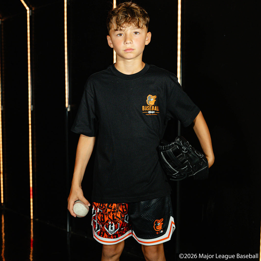 Youth model wearing black youth graphic tee with "Baltimore Orioles Ice Cream Cap" design