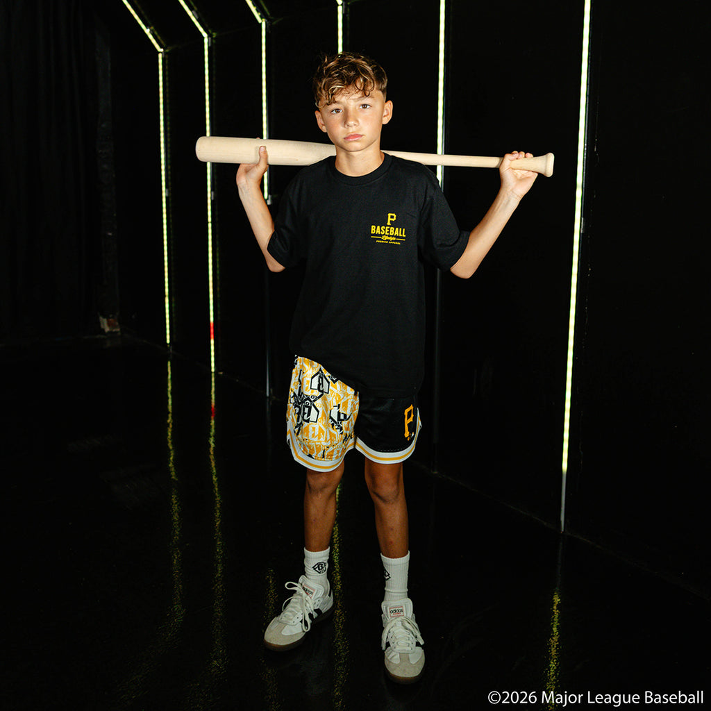 Youth model wearing black youth shorts with "Pittsburgh Pirates Sticker Court" design
