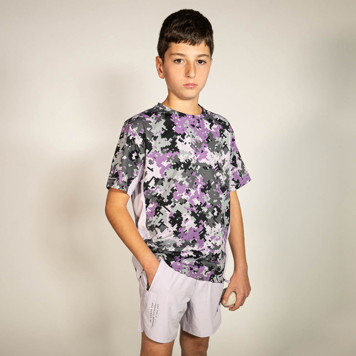 Youth model wearing purple Pro Series V2 youth shorts with liner