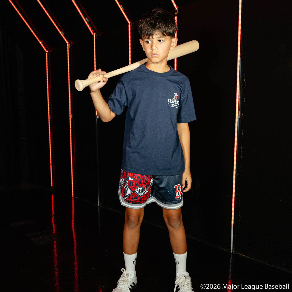 Youth model wearing navy youth shorts with "Boston Red Sox Sticker Court" design