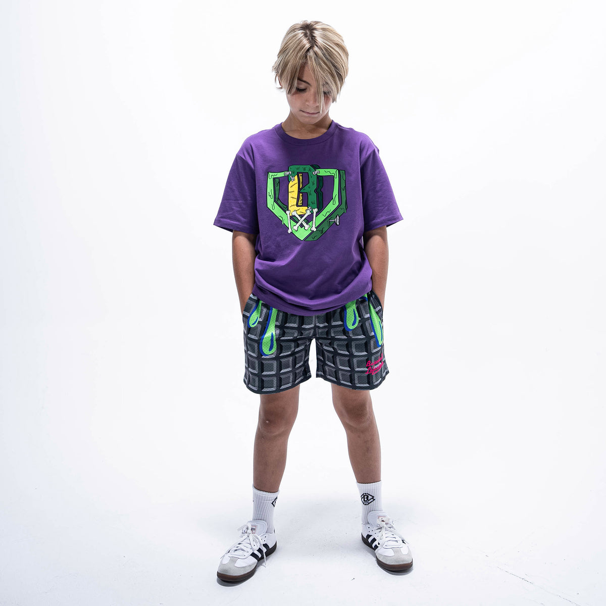 Youth model wearing black youth shorts with "Spooky SZN Waffle" design