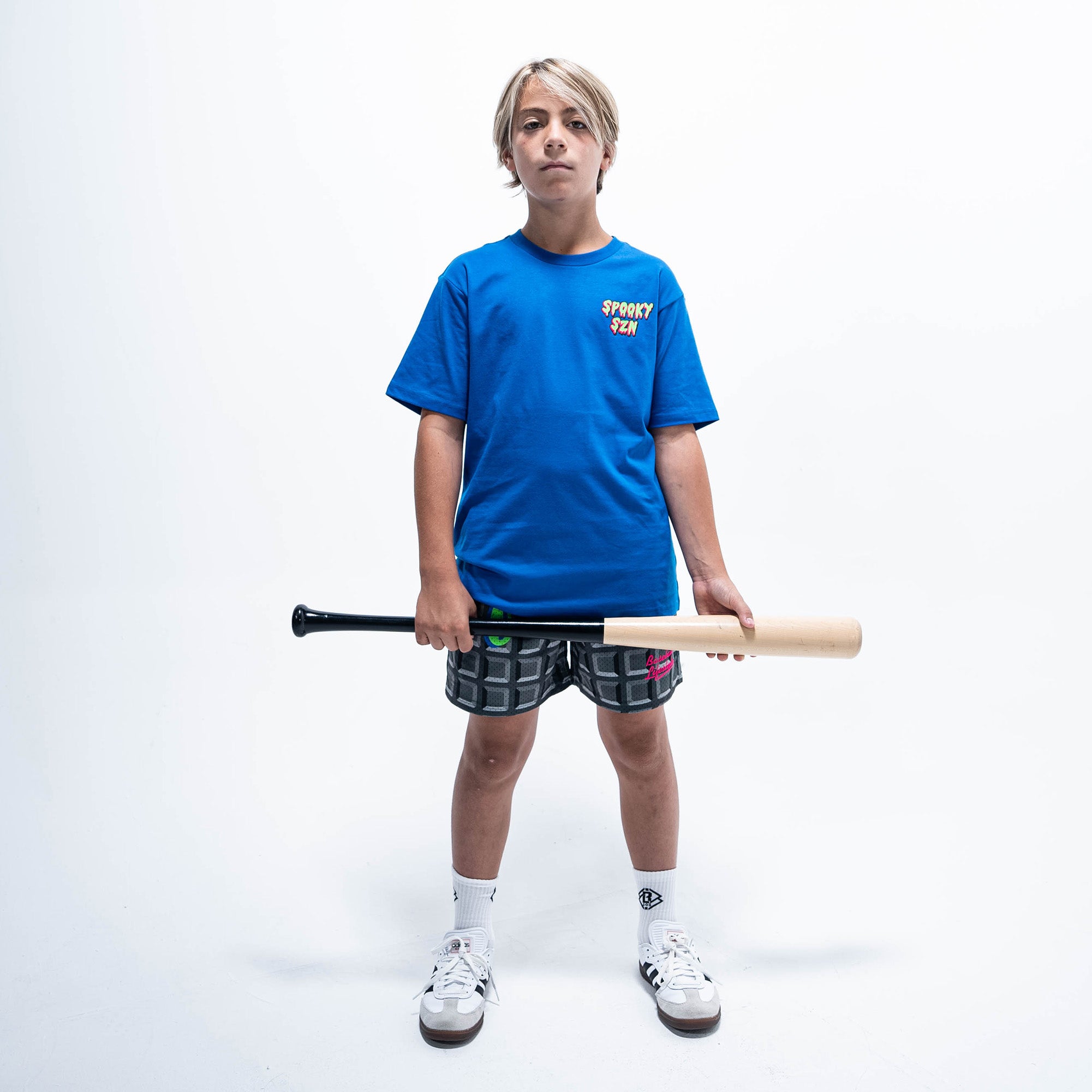Youth model wearing blue youth graphic tee with "Spooky SZN Waffle" design