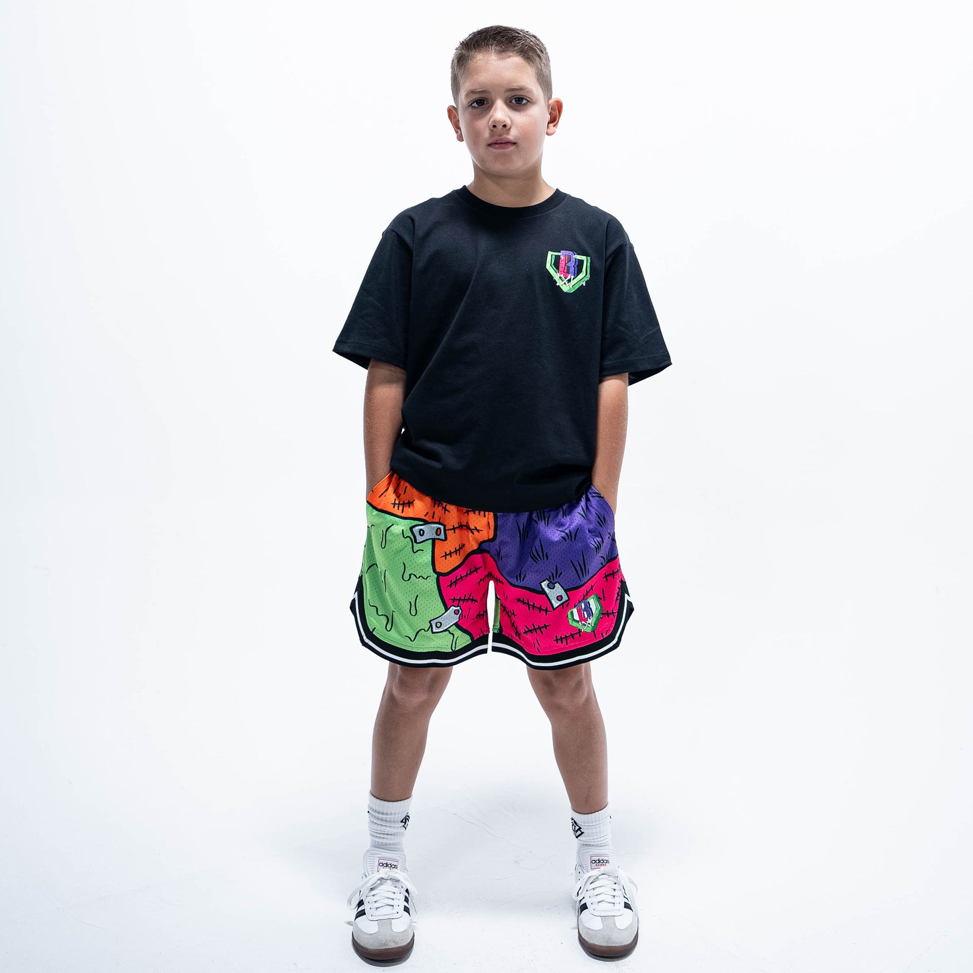 Youth model wearing black youth graphic tee with "Stitched For The Show" design
