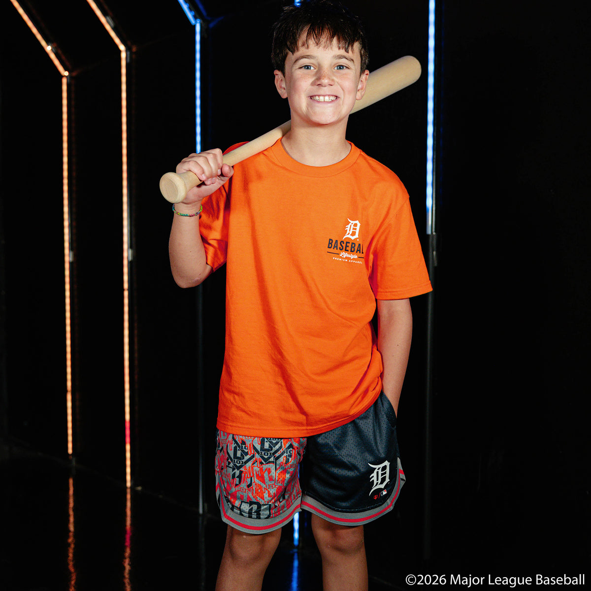 Youth model wearing orange youth graphic tee with "Detroit Tigers Ice Cream Cap" design