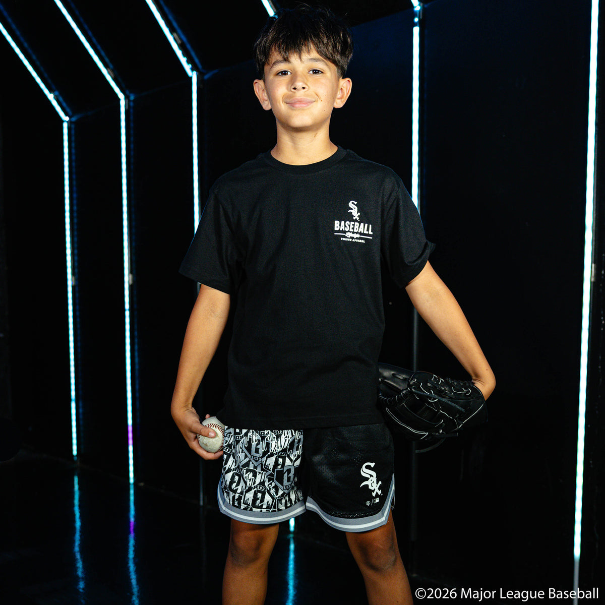 Youth model wearing black youth shorts with "Chicago White Sox Sticker Court" design