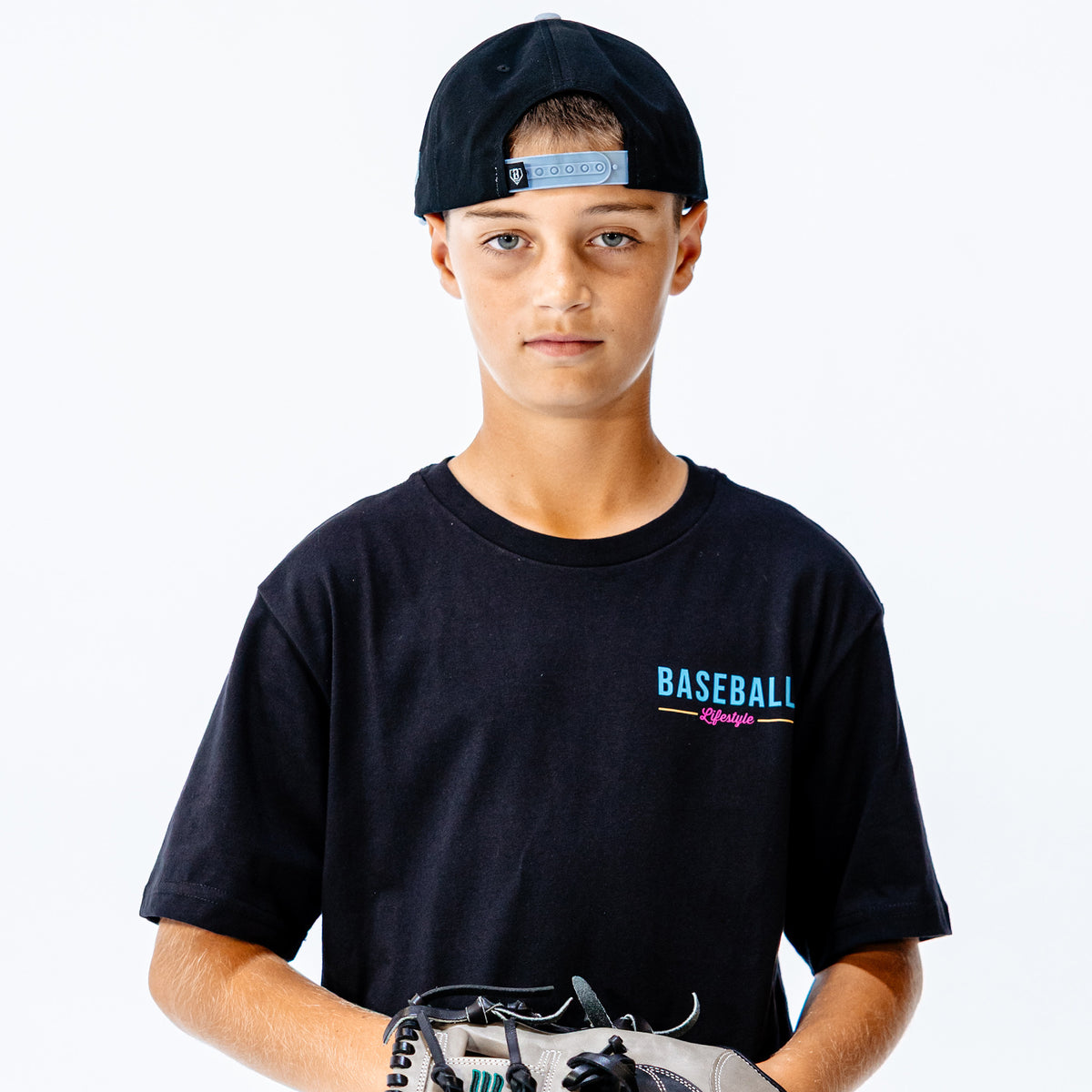 Young person wearing a black t-shirt with 'BASEBALL Lifestyle' text, holding sports equipment on a white background