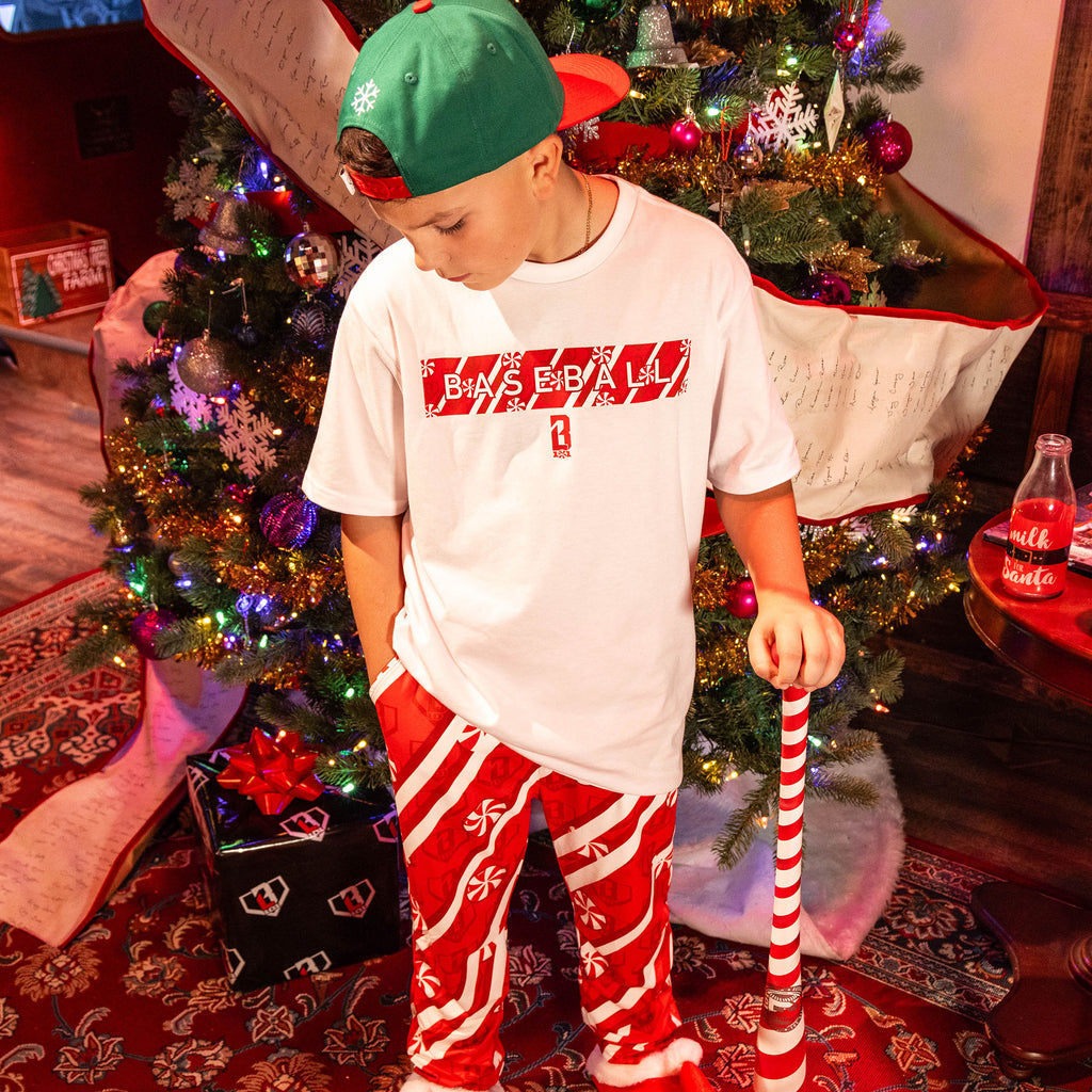 Child wearing Red pants with candy cane design and BL101 logo 