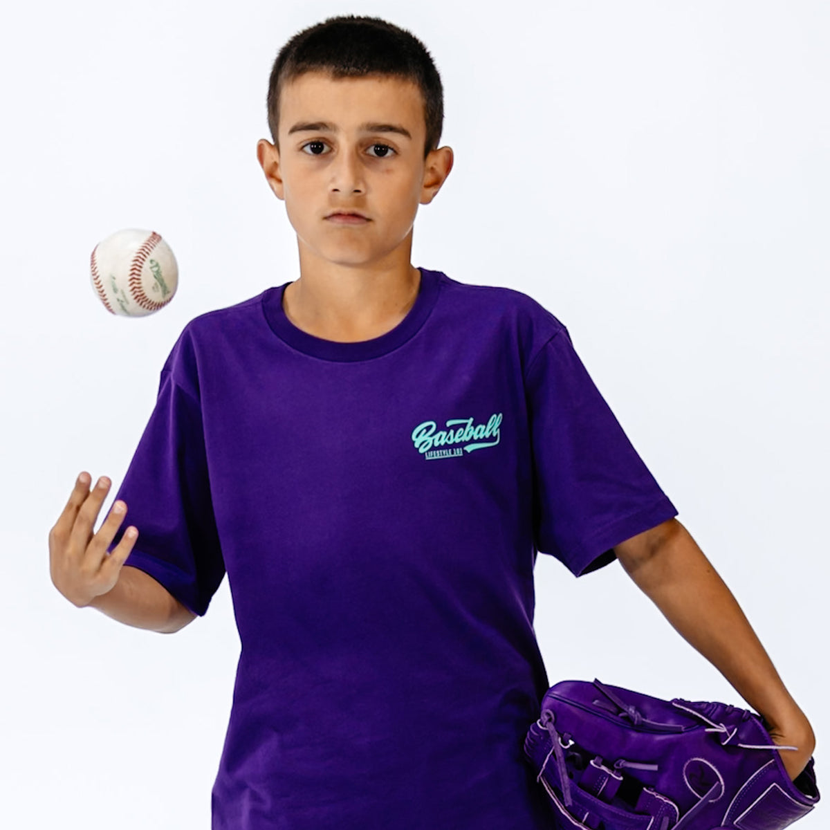 Boy in purple 'Baseball' t-shirt with a baseball and glove on a white background