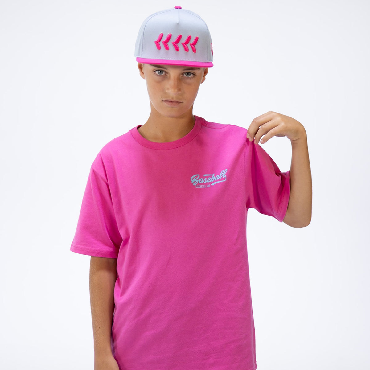 Person wearing a pink t-shirt and cap on a white background