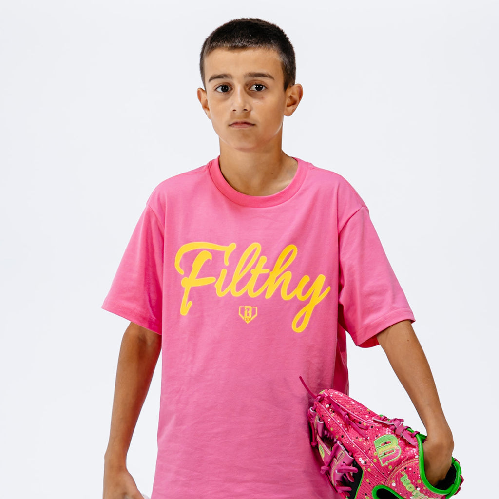 Person wearing a pink t-shirt with 'Filthy' printed in yellow on a white background