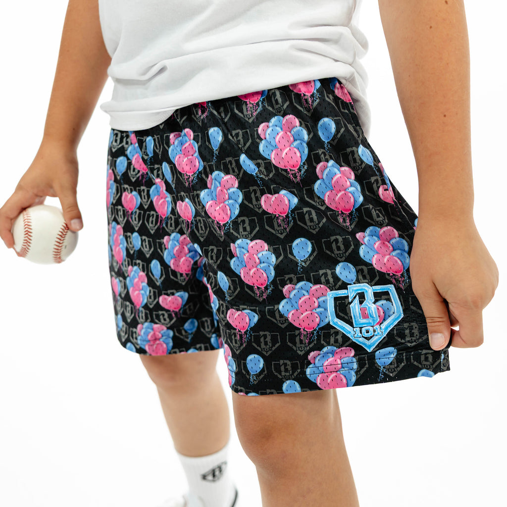 Youth model wearing blue youth shorts with "10 Year Anniversary" design