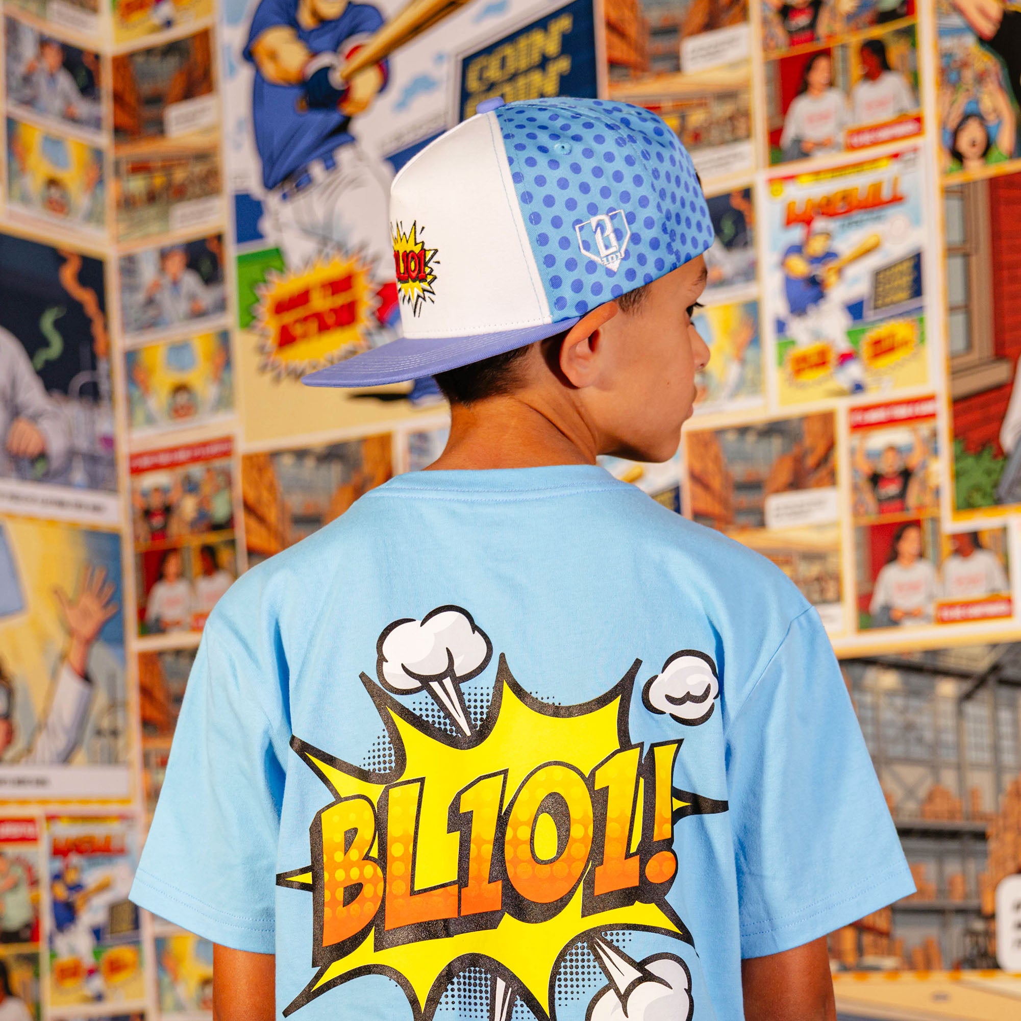 Youth model wearing blue hat with "BL101 Comic" design