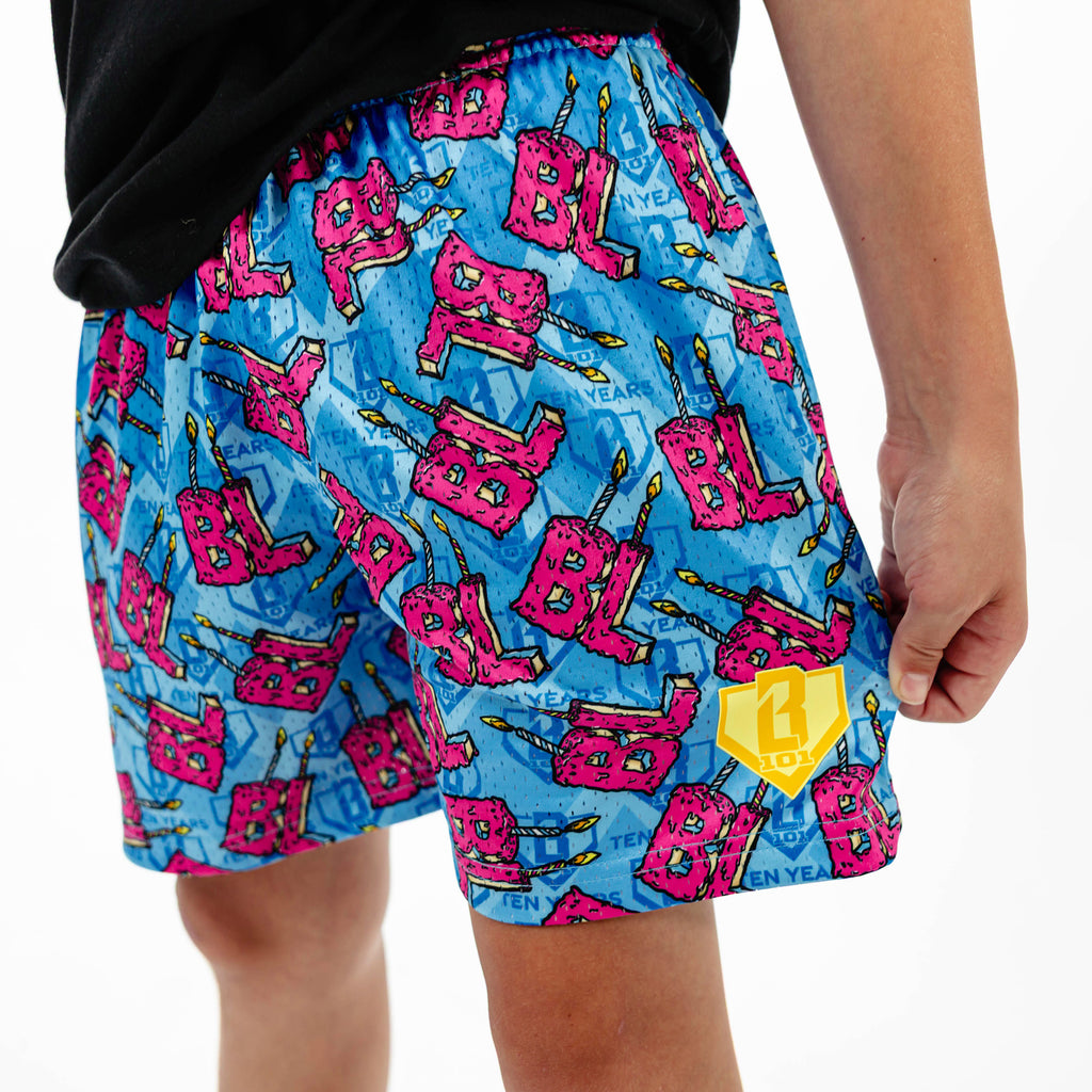 Youth model wearing blue youth shorts with "BL Birthday" design